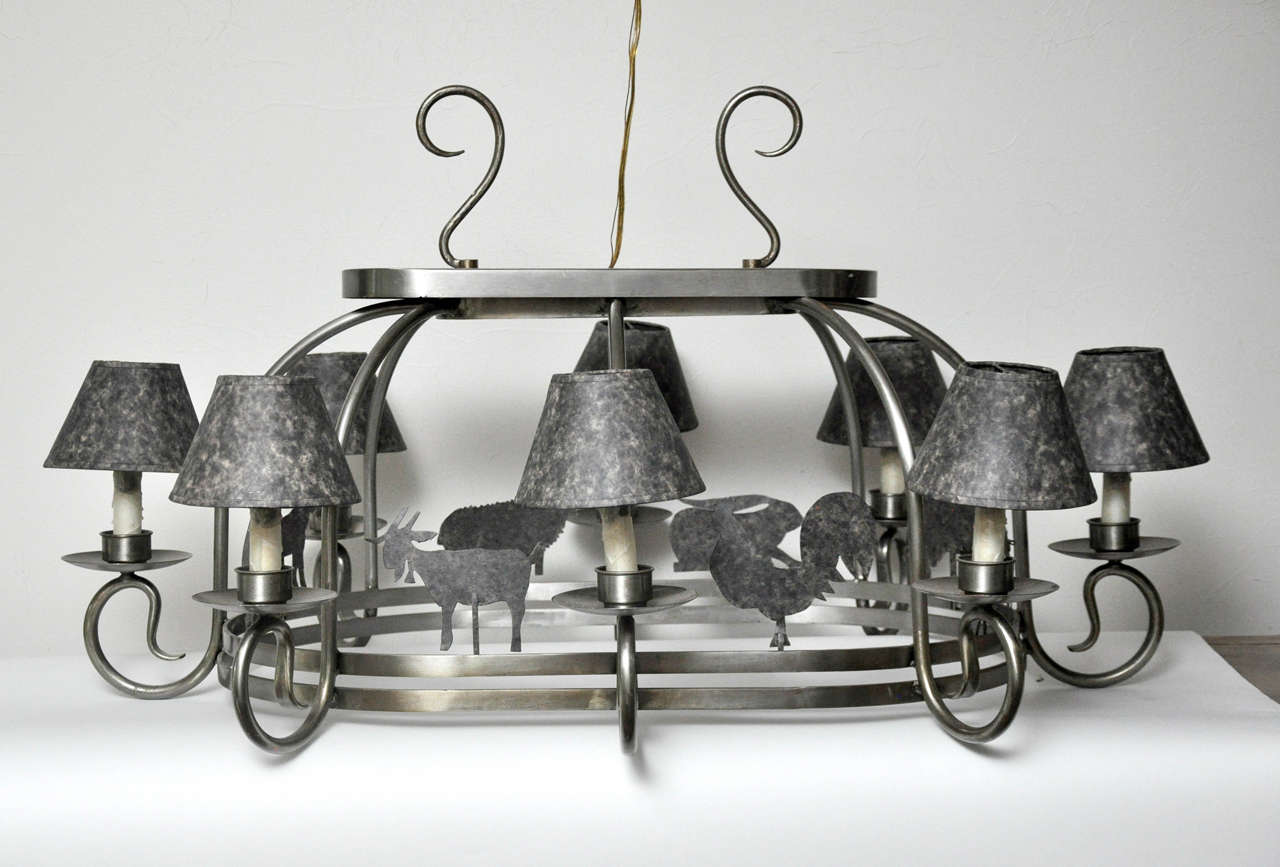 Farm animal cut outs line the double banded base of this oval chandelier. Made of pewter color metal with individual matching lamp shades.