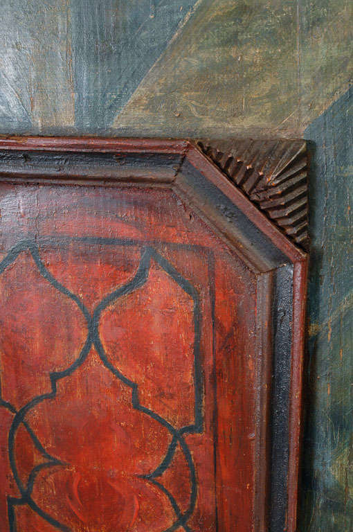 A painted pine armoire to which it is hard to do justice. The piece was built with no nails, only wooden pegs were used even to the width of the finest brad. The removeable crown with such pronounced angles obscures a cleated mortice and tenon