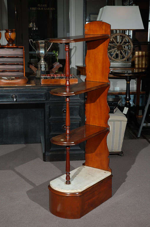 Late 19th century English chemist mahogany shelf. The oval shelves meet with turned columns above the lower marble top shelf over a secret back drawer.