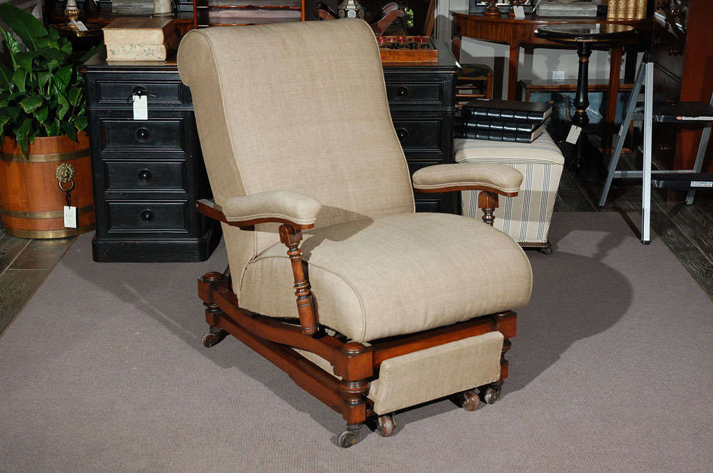 1870s English recliner. This is a delightful example of a pre-modern reclining lounge chair with full functionality intact. A testament to late 19th-century English craftsmanship and design, the turned mahogany framework features an adjustable back