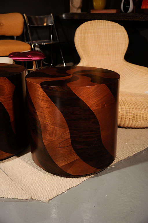 Spectacular pair of wood drum tables with alternating dark and light walnut veneers in a peppermint candy swirl pattern. Each floats upon a plinth base. Guaranteed to bring the wow-factor to the room.
