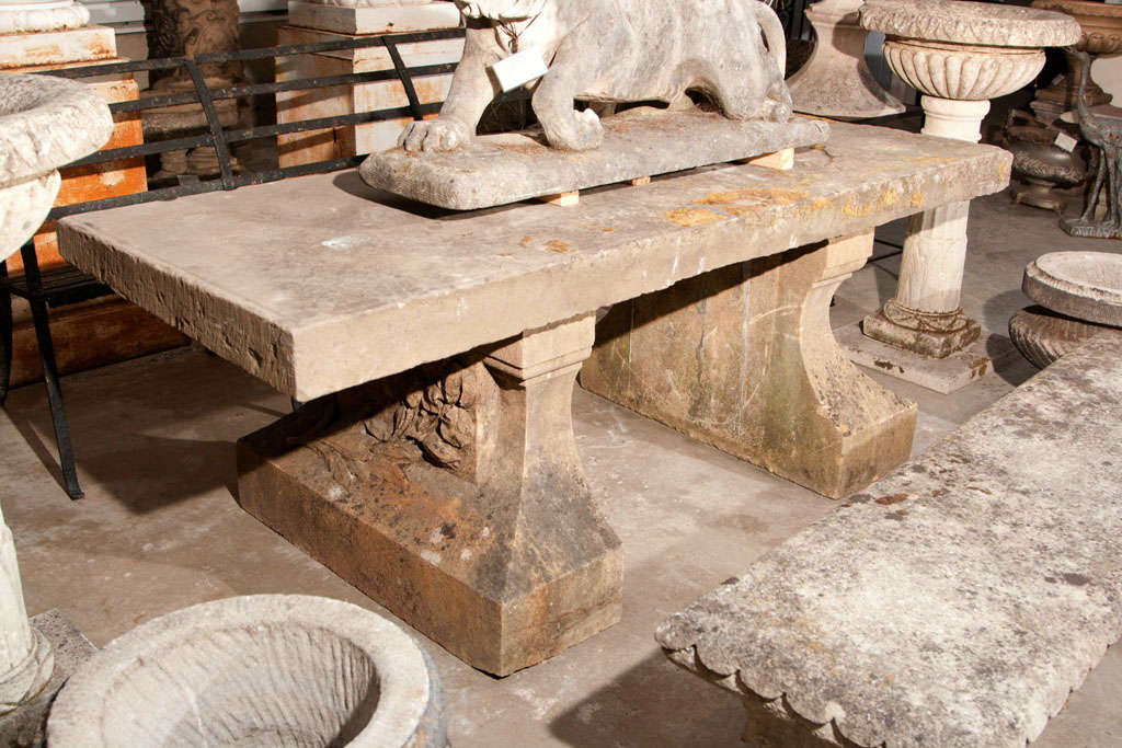 This stone table is over the top! With a single slab top measuring 4 inches thick and supports with incredible irises carved in bas relief, this is the ultimate outdoor dining table. Imagine this beauty on a soft summer evening, underneath a