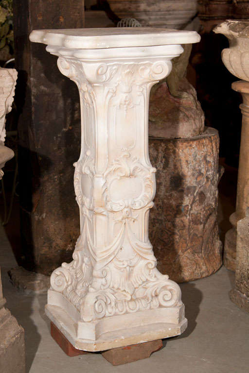This graceful, tall, plaster pedestal features a clean cream-colored surface and fine detailing on the column. Perfect for an extravagant floral arrangement or statue as the focal point in an entry hall or library. This piece must remain indoors or