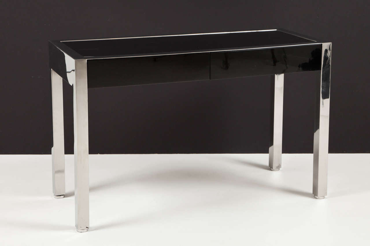 Polished stainless steel frame with inset black lacquer drawer fronts and writing surface. Sumptuous minimalism by Leon Rosen for Pace Collection.
Lacquer surfaces newly restored to original specification.

       