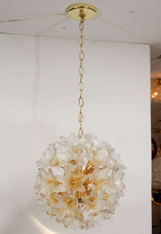 Incredible glass flower sputnik ceiling light. Dozens of glass flowers attached to brass stems and center ball. Each textured glass transitions in color from a soft gold center to clear petals. Professionally rewired. An exquisite piece to highlight