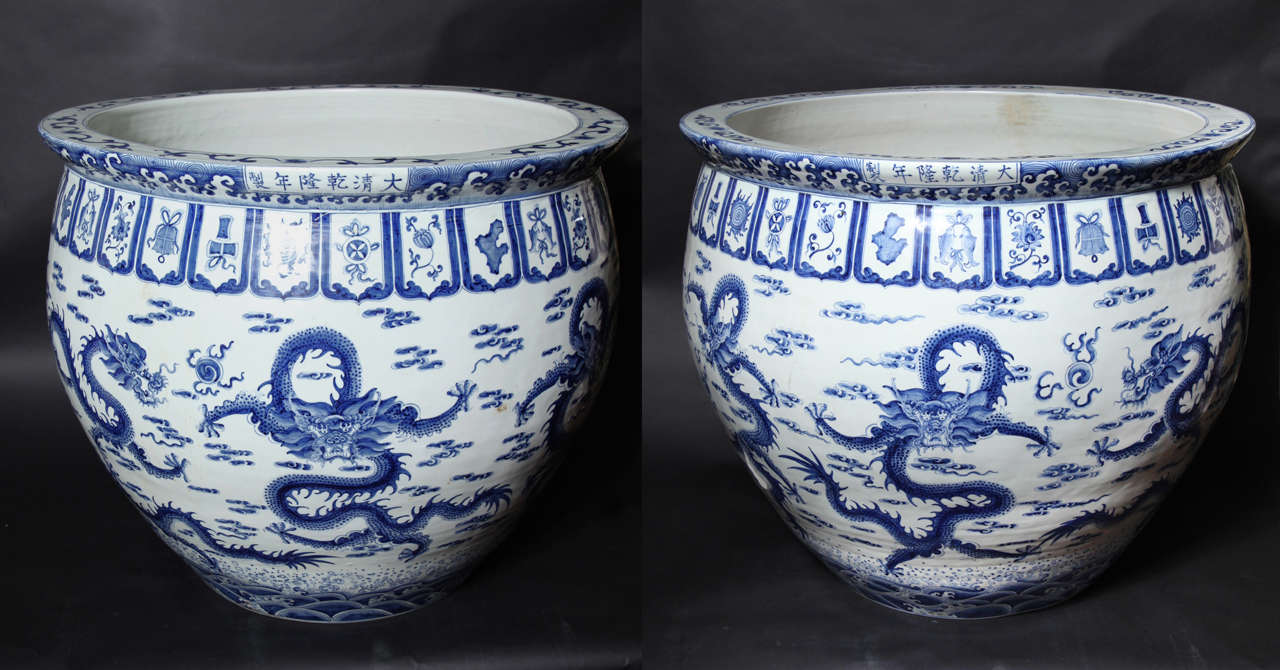 A Pair of Chinese Blue and White Jardinaiers or Fish Bowls. They bear a Ming dynasty reign mark , probably apocryphall. The decoration consists of 5 clawed dragons in pursuit of the flaming pearl of knowledge.The upper border consists of precious