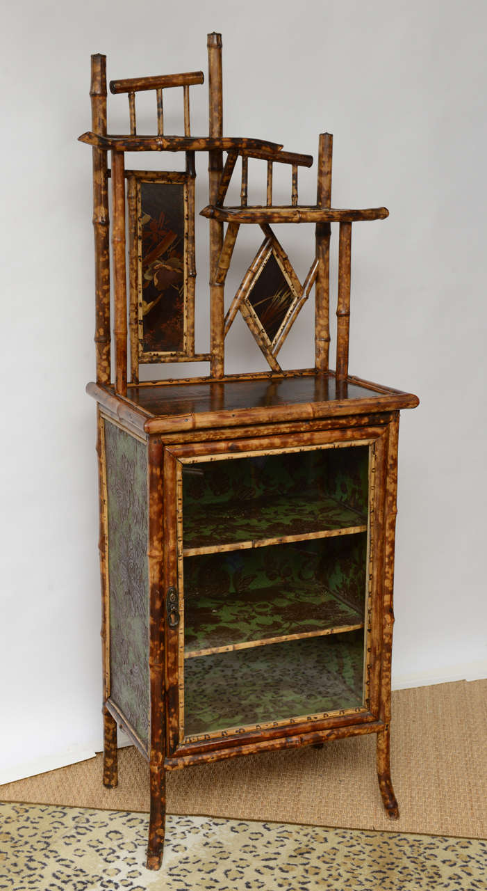 Beautiful 19th century bamboo cabinet and étagère with lacquer japanning on top and two front panels. (All original).
Also it's recover inside and outside with leather paper.
Original handle.
Great for books., dishes and bathroom.