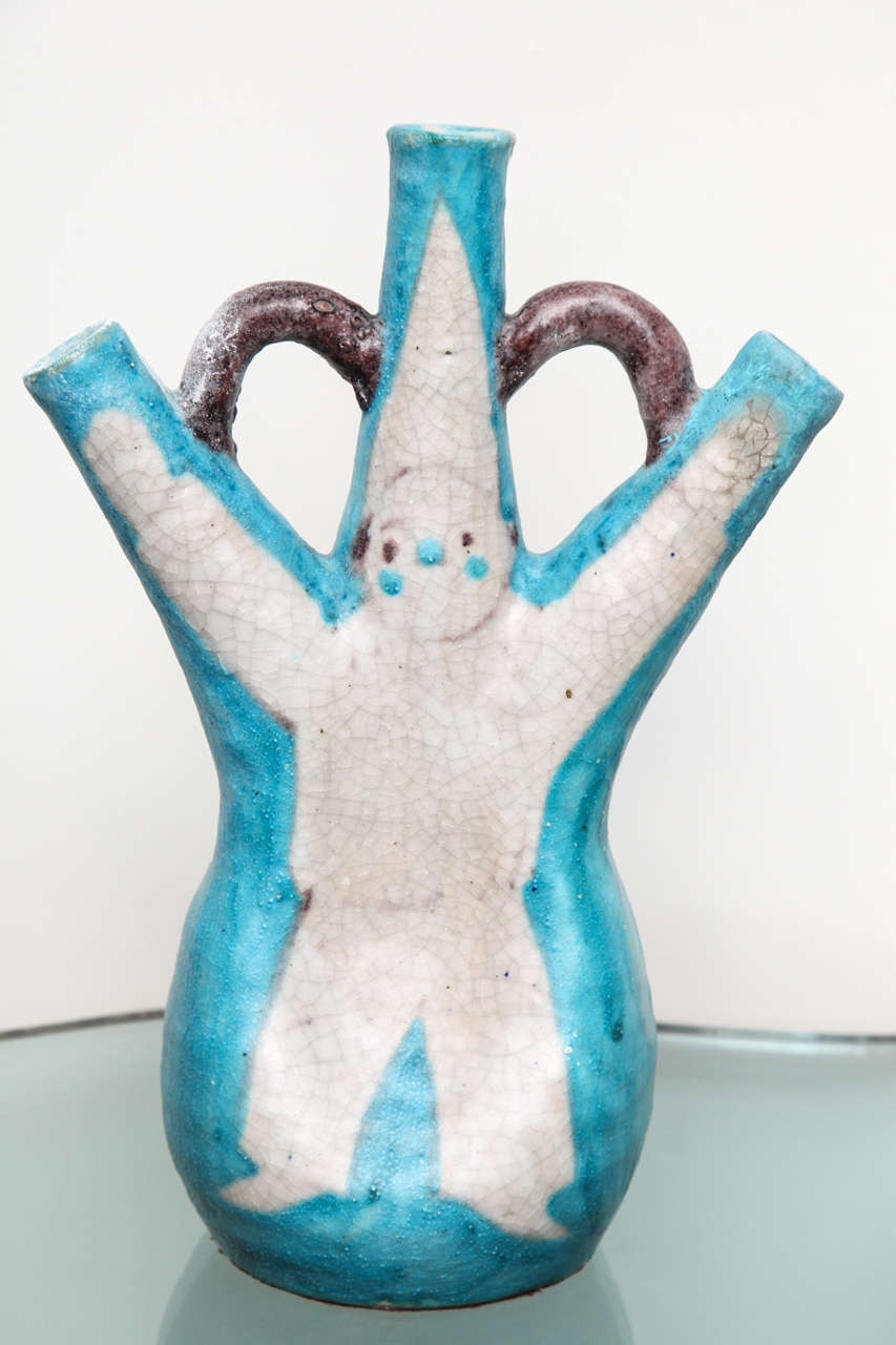 Playful and sophisticated ceramic vessel. Hand-thrown with blue, brown and white salt glaze, and clown figure decoration. This piece is done in the spirit of works by Guido Gambone. Signed on underside.