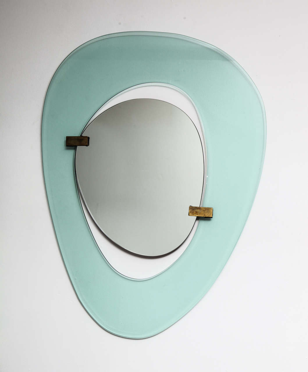 Crystal surround in sea-foam green, with floating central mirror and brass mounts.  This rare model was conceived during the height of Fontana Arte's post-war creative period and while the company was under the design direction of Max Ingrand.