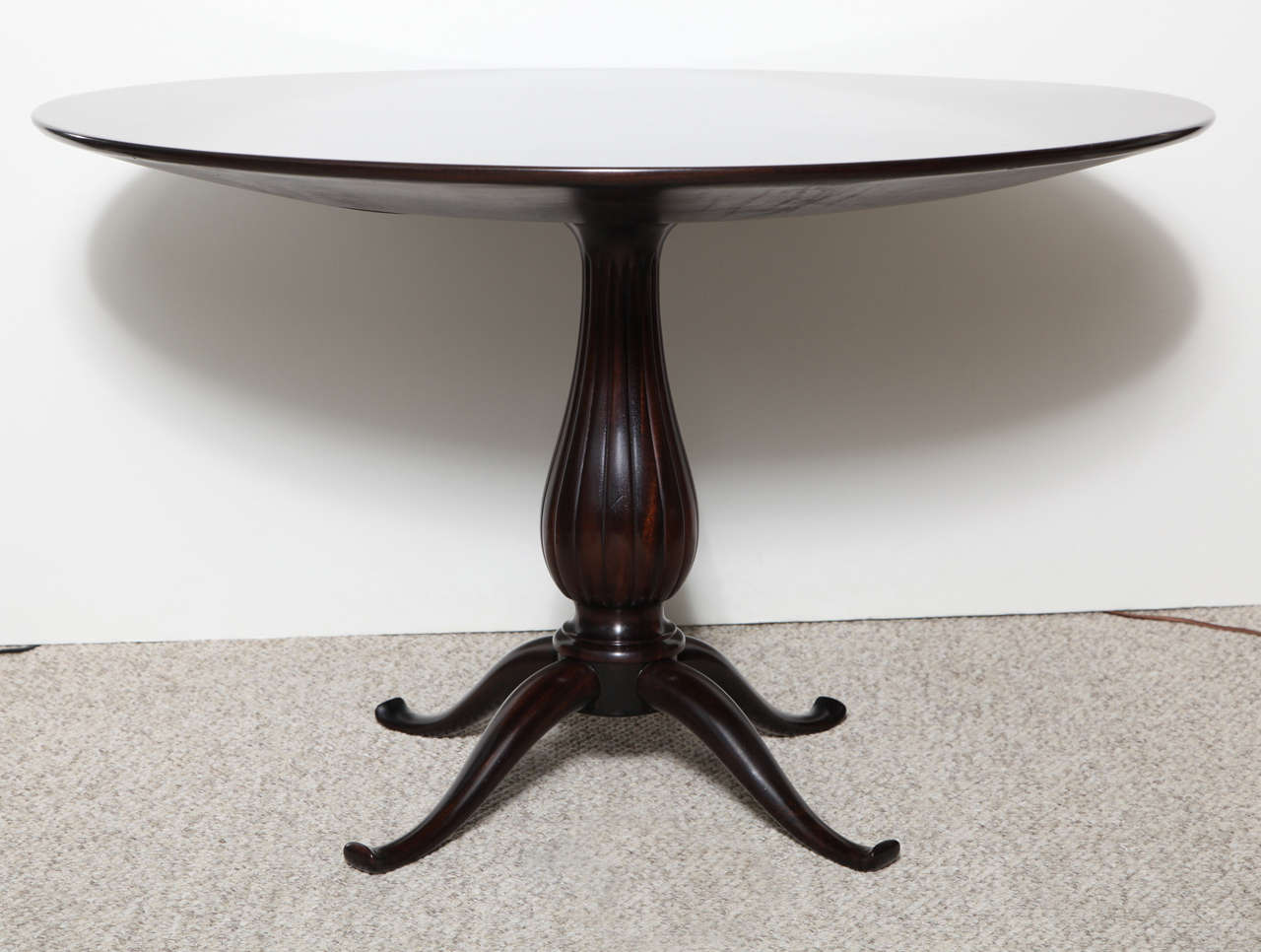 Mahogany top with inlaid star-burst pattern.  Pedestal base with carved bulbous center piece the evolves into four graciously curved feet.