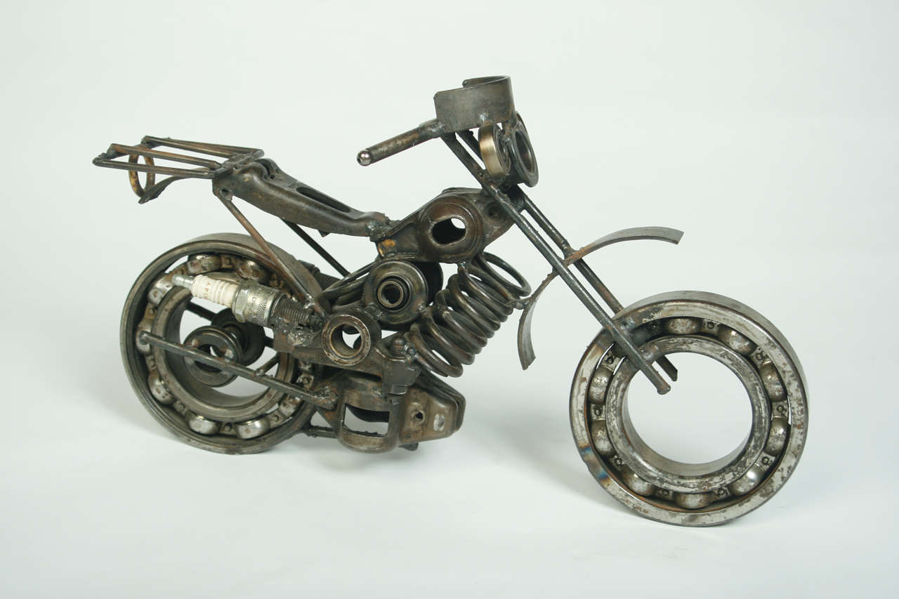 One of a kind motorcycle sculpture made from old car parts. Great look!