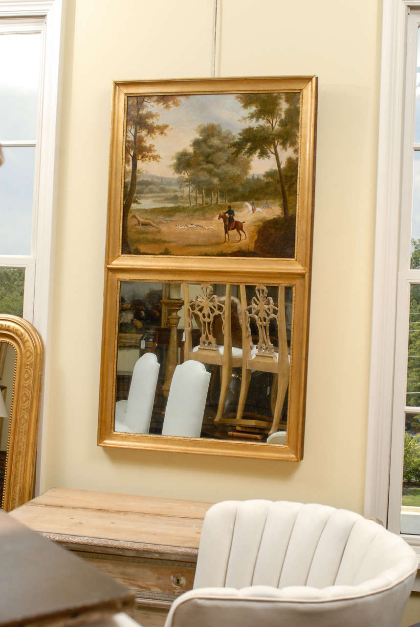 A 19th century French trumeau mirror with hunting scene. This French trumeau mirror from circa 1870 features an oil painting in its upper section, depicting a scene of the hunt. Placed in a country setting, the painting is composed very carefully.
