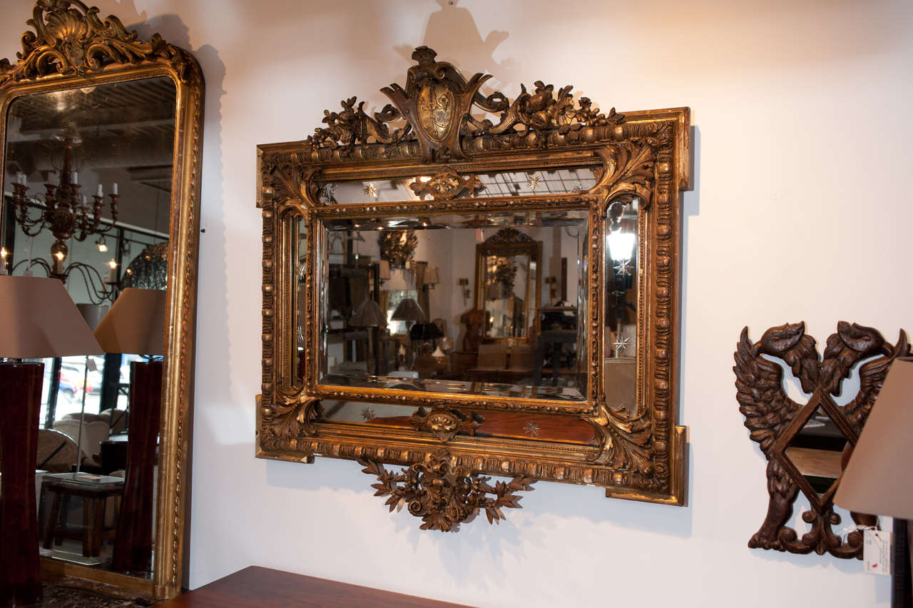 Horizontal Flemish cushion mirror with original goldgilt frame and detailed egg and dart crown