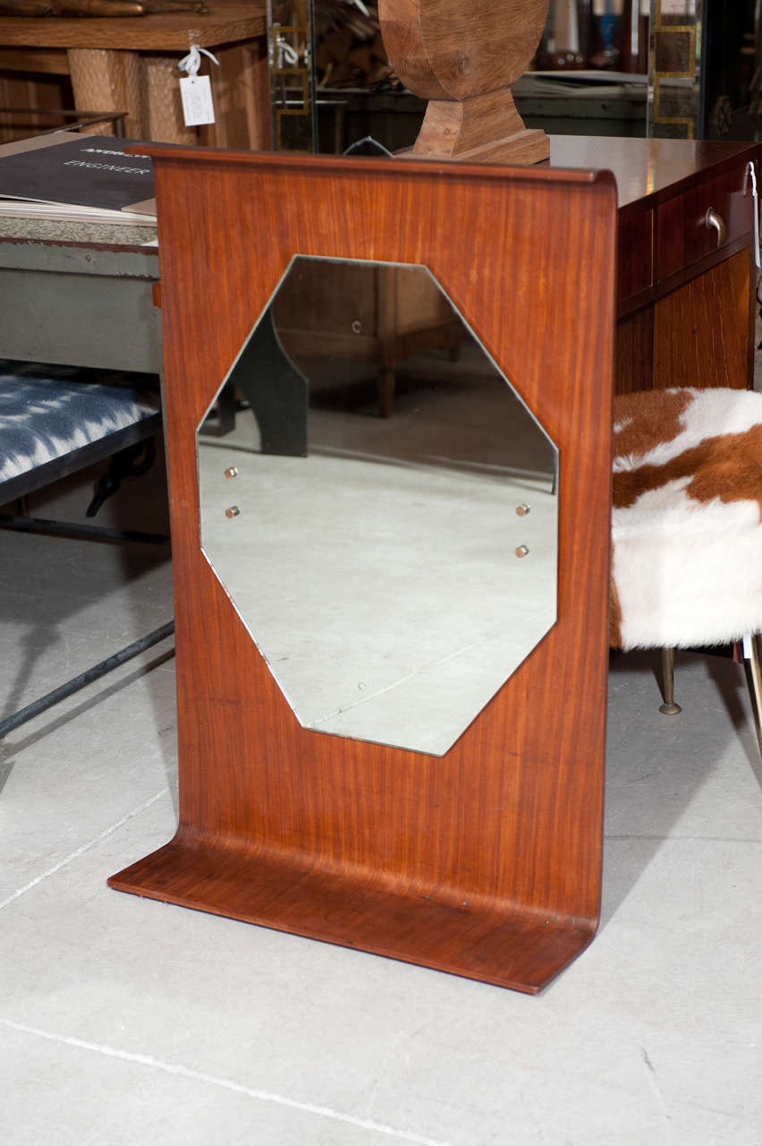 mahogany  with original octagonal mirror bolted  in place .  Integrated 