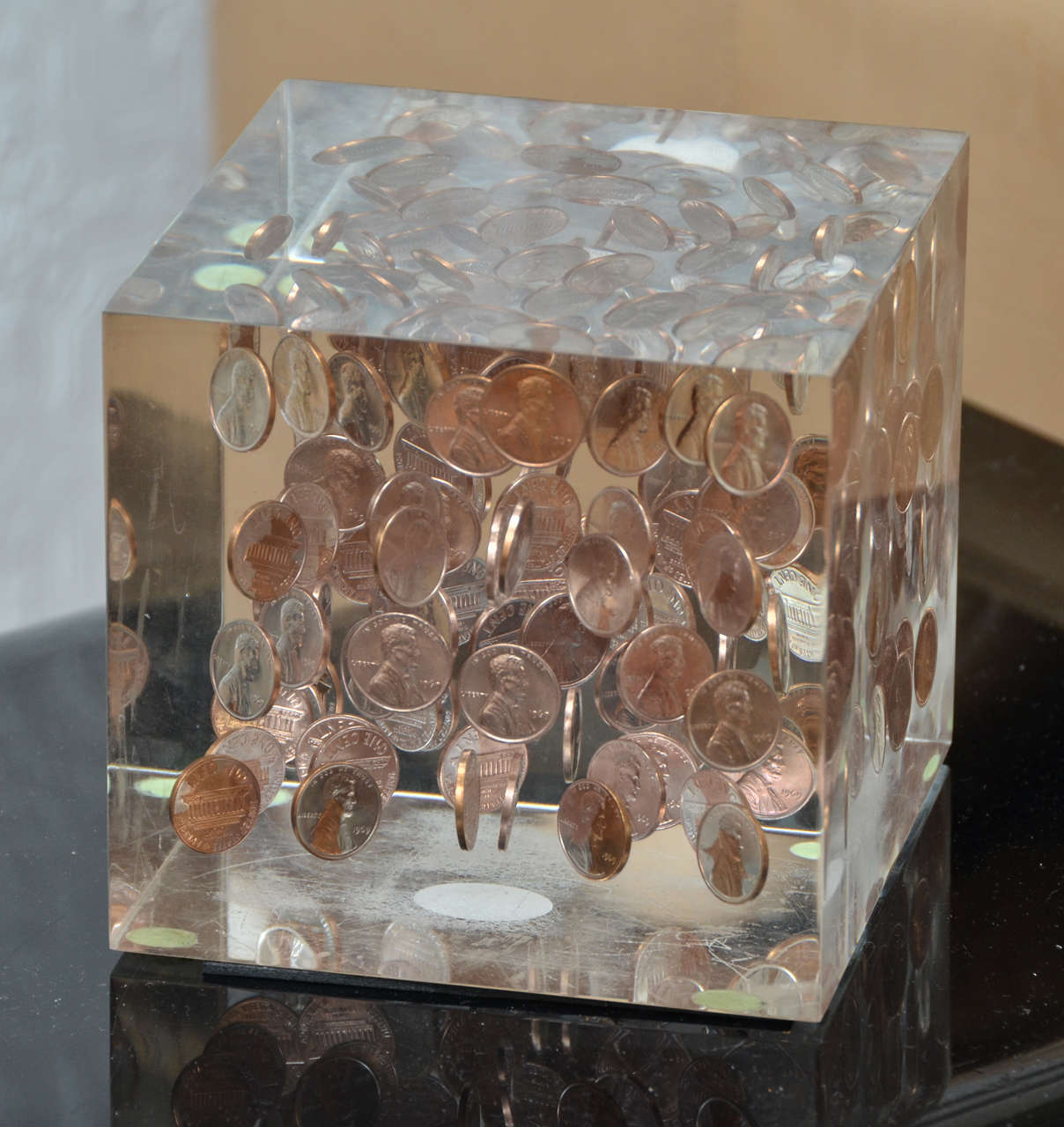 Square lucite cube, with 1969 floating pennies.