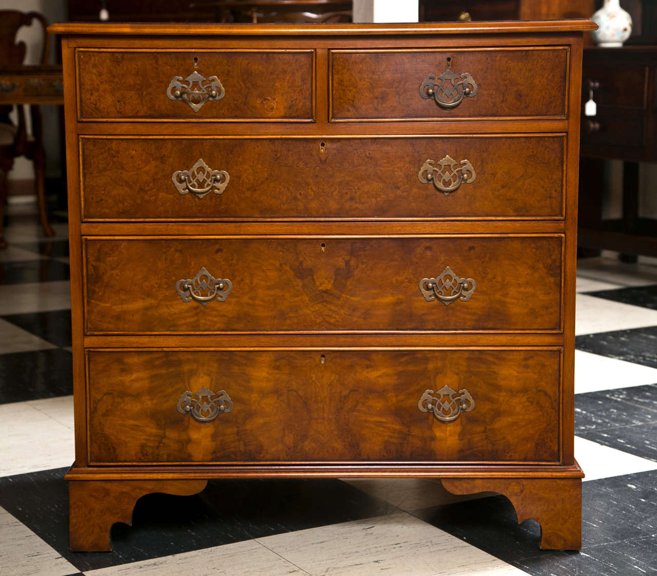 Beautiful burled walnut encompasses the top and front of this custom chest while a handsomely striated grained walnut covers the sides. Oak-lined drawers speak of the quality and attention to detail in this chest, which is proportioned well for