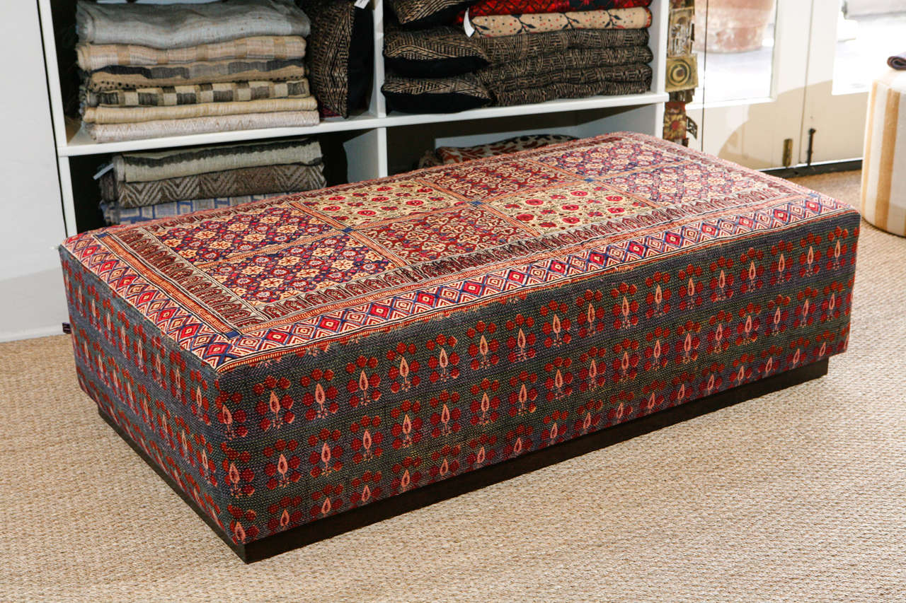 Large Ottoman made from vintage quilted Indian kalamkari and block printed textiles.  Recessed mahogany stained kick at bottom.