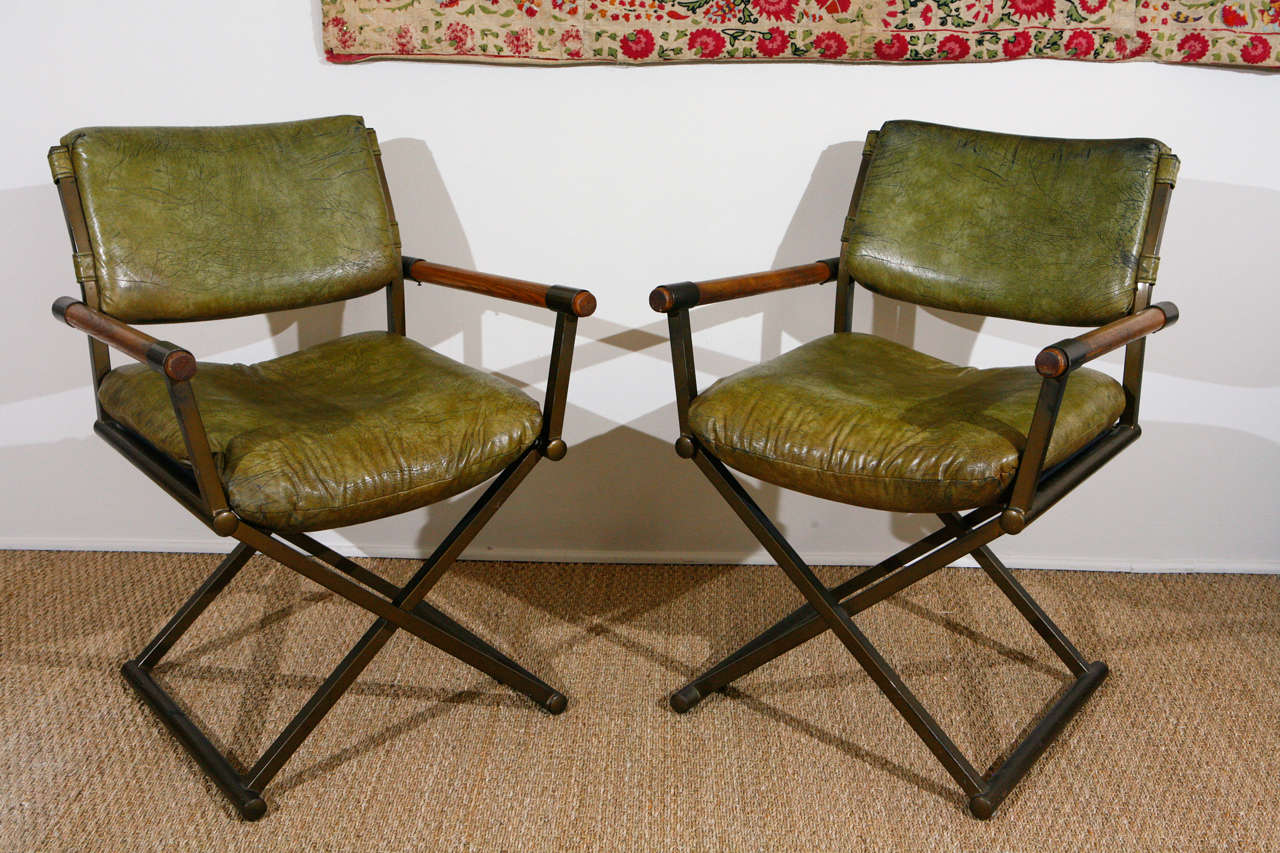 Powder coated bronze color steel, wood arms with original olive green vinyl.
TWO SOLD.  One available at $750.