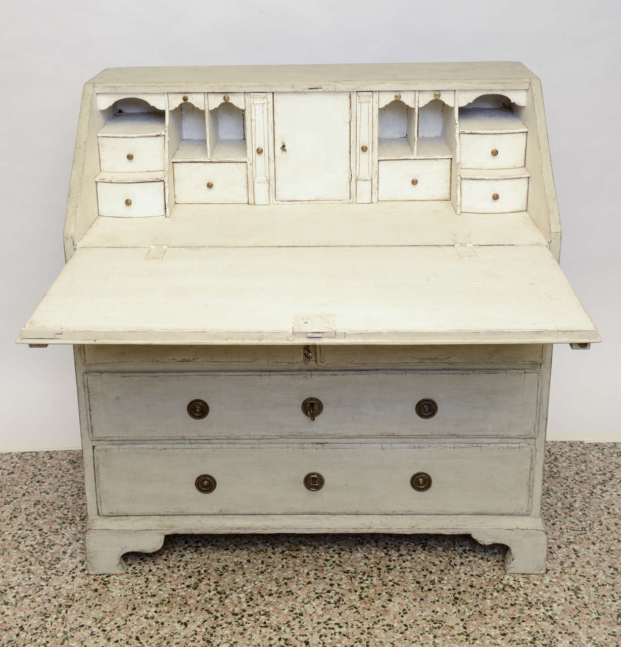 Antique Swedish Period Slant Front White Writing Desk, circa 1760's with slant front and bracket base.  Multiple drawers and pull out compartments behind the writing surface with one over two drawers below.