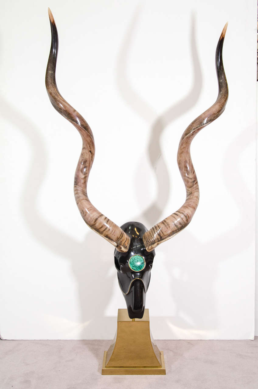 A vintage memento mori sculpture depicting an ibex skull in black fiberglass with large horns and a malachite roundel. The piece sits atop a brass pedestal base.

Reduced from: $12500