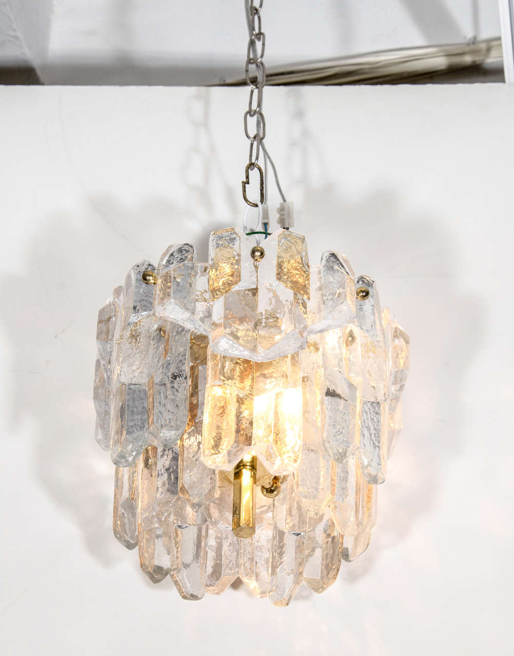 A vintage Austrian crystal chandelier with prisms suspended from a brass body by Kalmar.
