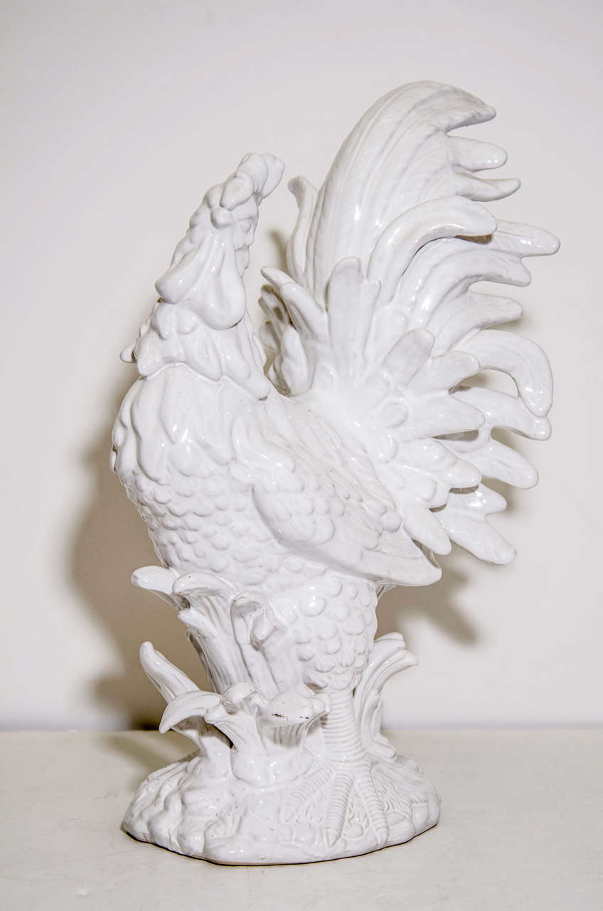 A highly detailed sculpture in white ceramic of a standing rooster