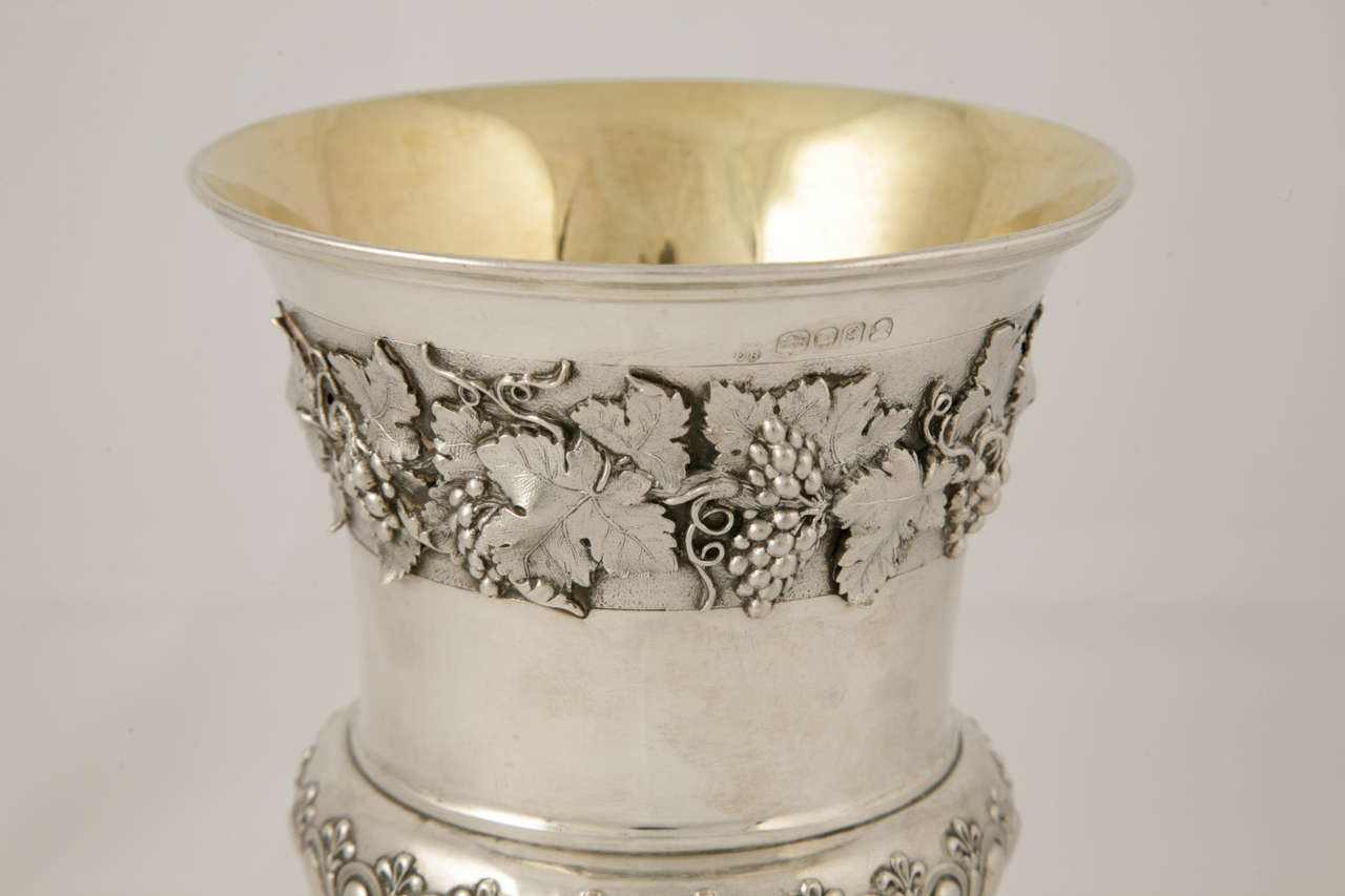A fine antique English silver goblet, made in London 1822, by John Emes and Edward Barnard.
The goblet is of exceptionally heavy gauge with a beautifully detailed band of grapevine and leaf applied decoration. It has a beautifully gilded