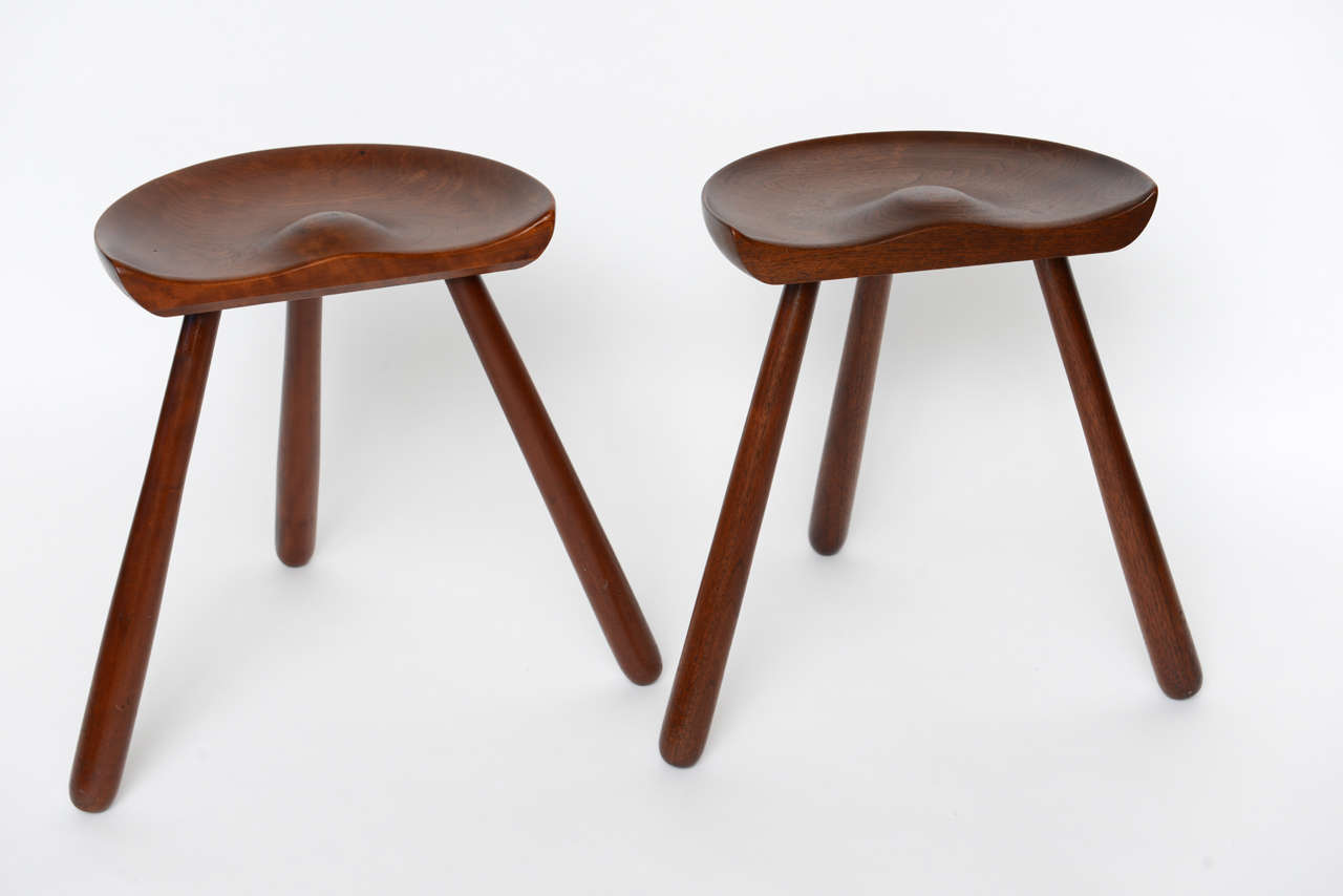 Pair of Danish walnut stools with contoured seats and splayed legs, in the manner of Mogens Lassen.