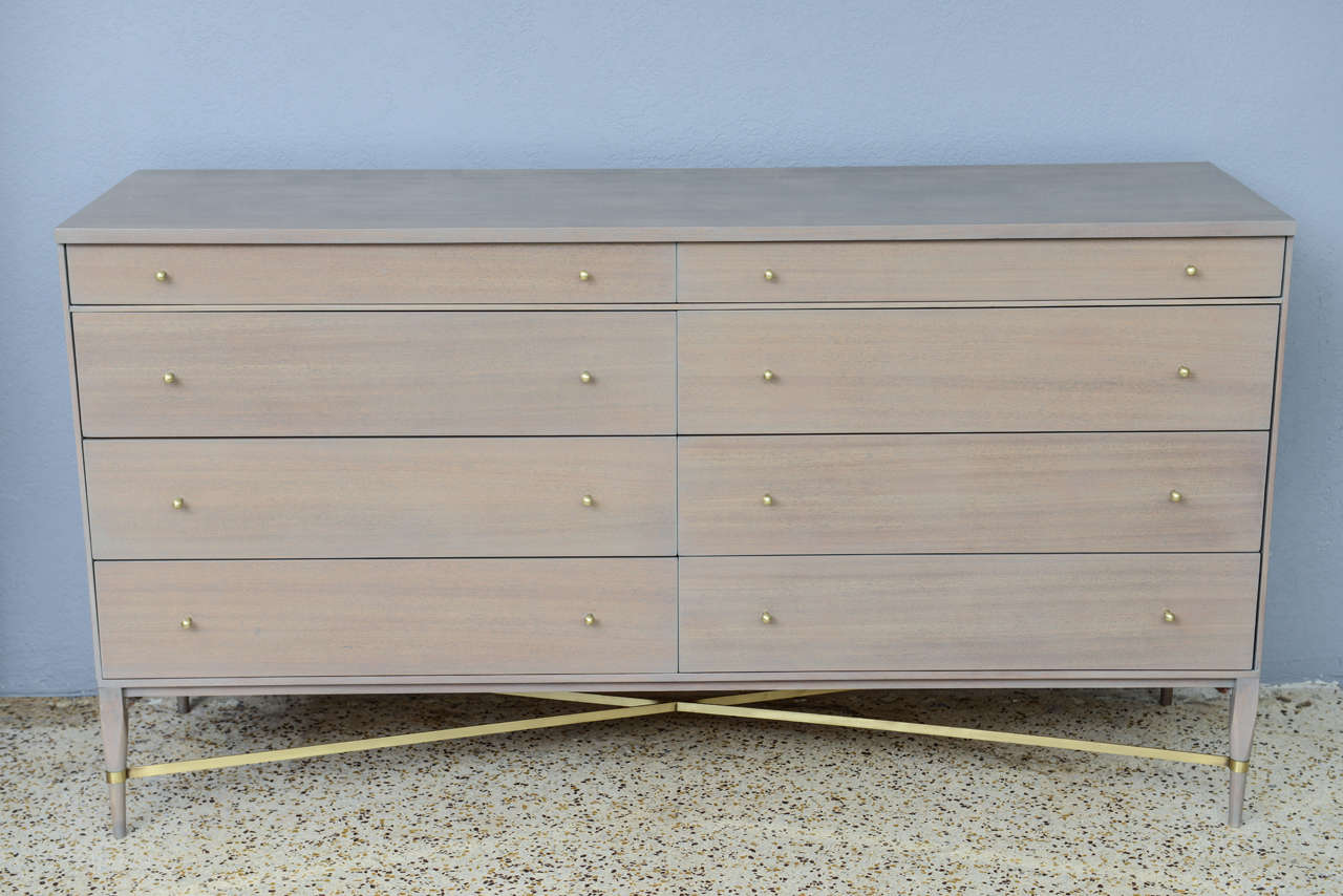 We've updated this eight-drawer, bleached walnut dresser by Paul McCobb with our signature driftwood-grey wash, and taken it from inspired utility piece to gorgeous greige showstopper! Restored original hardware in brushed brass.