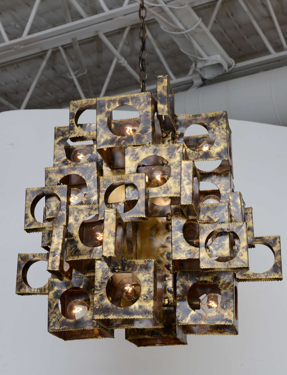 Impressively-scaled, torch-cut brass chandelier by T. A. (Tom) Greene for Feldman Lighting. Brutalist sensibilities and Pop Art style marry in this 12-light stunner! Retains original Feldman sticker.