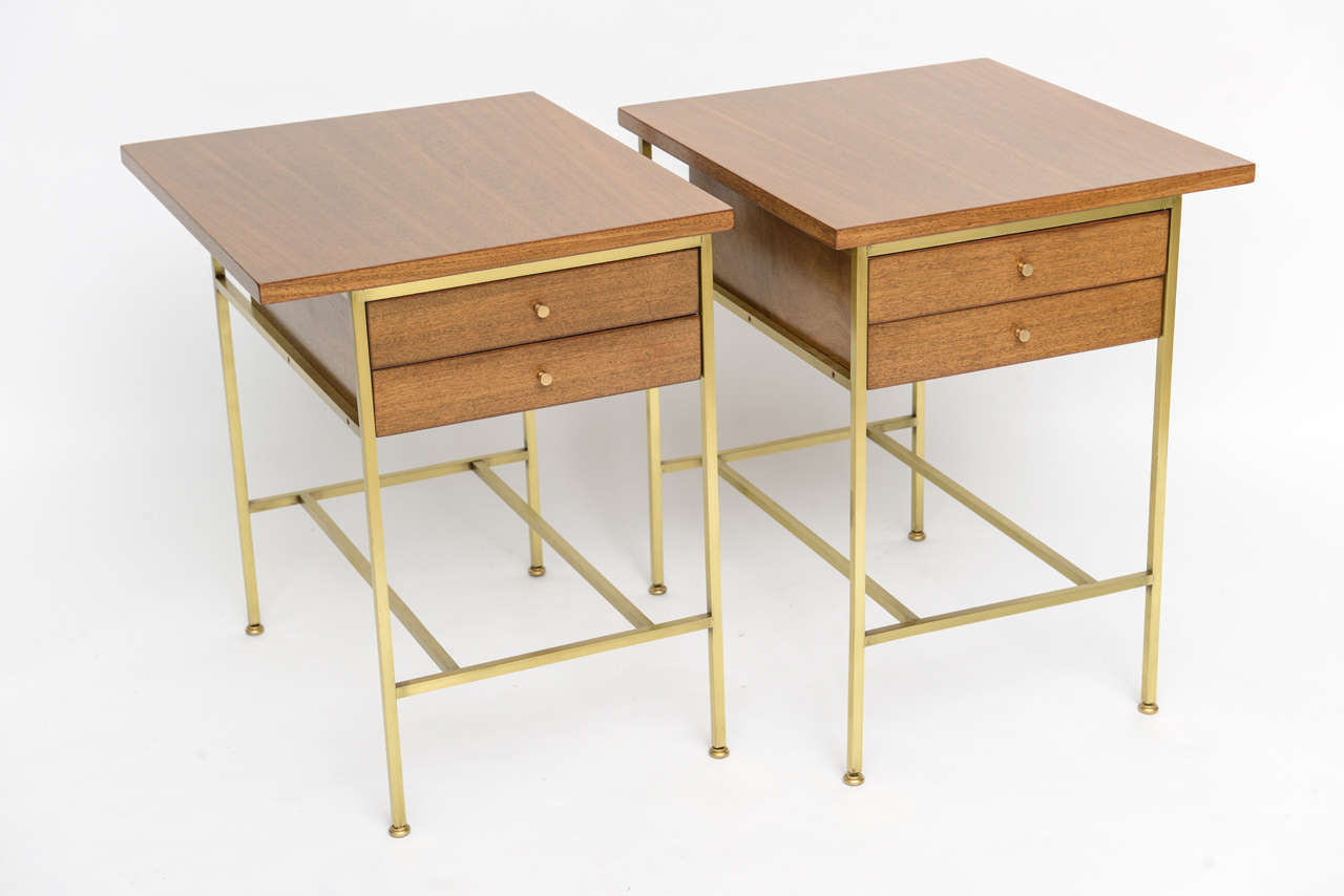 Sublimely simple end tables by Paul McCobb for Calvin. Mahogany with brushed brass frames and hardware.