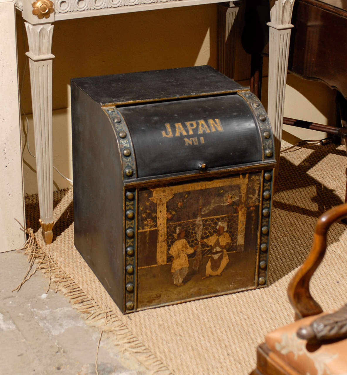 Large 19th Century English tole tea bin with a painted chinoiserie scene on the front and decorative buttons along the sides.  The curved sliding door is marked Japan.