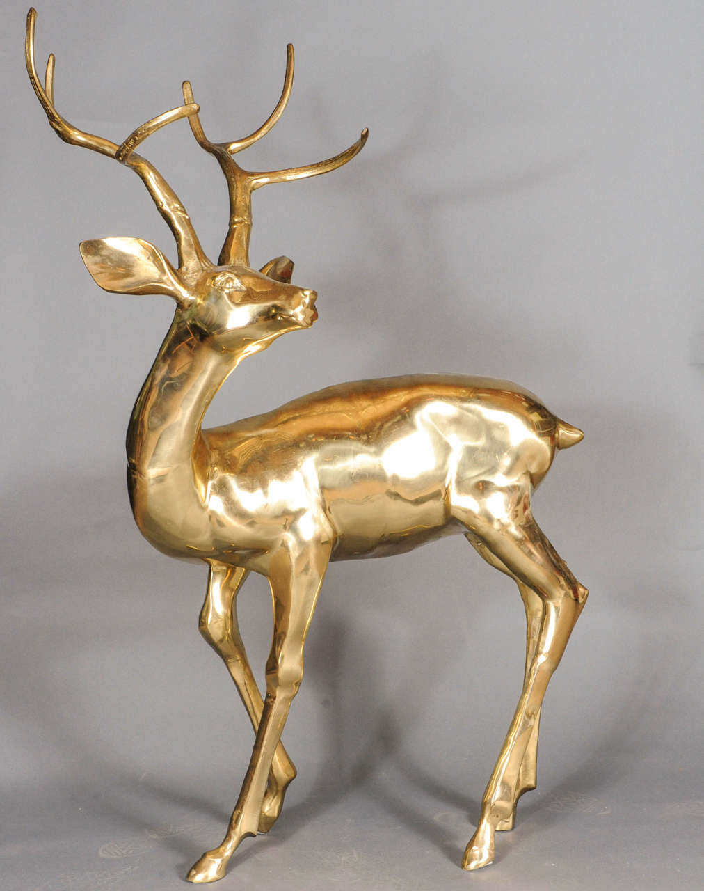 Amazingly sculpted brass deer with a gold top layer for the shiny effect. This is a wonderful eye catcher in any mid-century interior