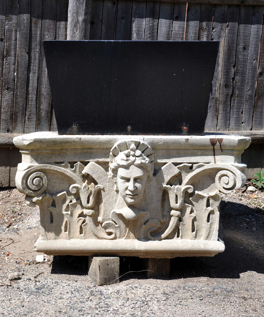 A Stone Archectural Capital / Planter with central female bust from an unknown Chicago area building, Circa 1900 with attached metal planter. Planter measures: Height: 14 in., Width: 26 in. Depth: 28 in