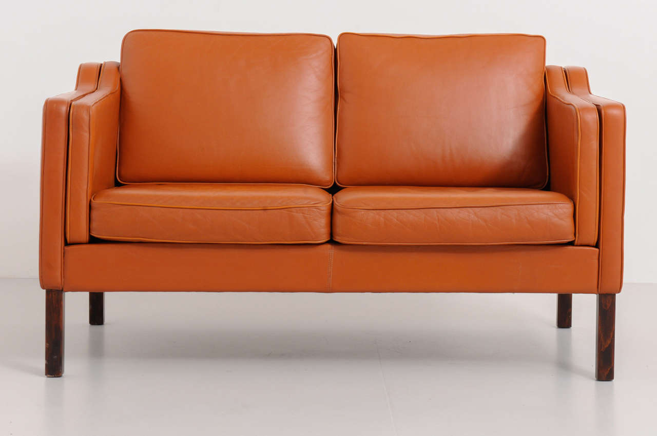 Very well conditioned two-seater sofa from Borge Mogensen for Fredericia Stolefabrik in Denmark. The leather is in used condition with nice patina, but in excellent condition.
The high legs still provide an open look to the sofa although it is