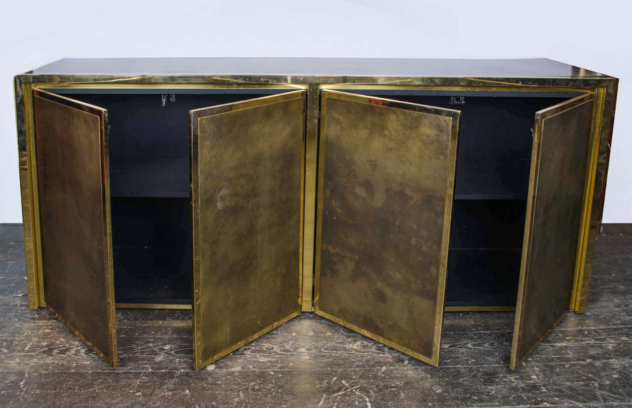 1970s Belgian four doors metal sideboard or cabinet, lacquered with antique gold finish and brass facings four doors.