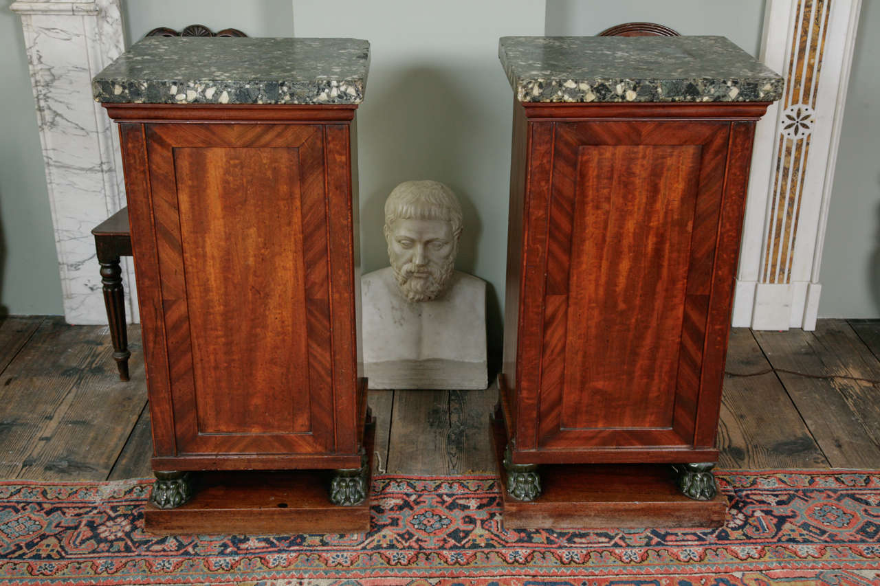 With original scagliola tops above fitted and lined cupboards on paw feet and plinth bases.