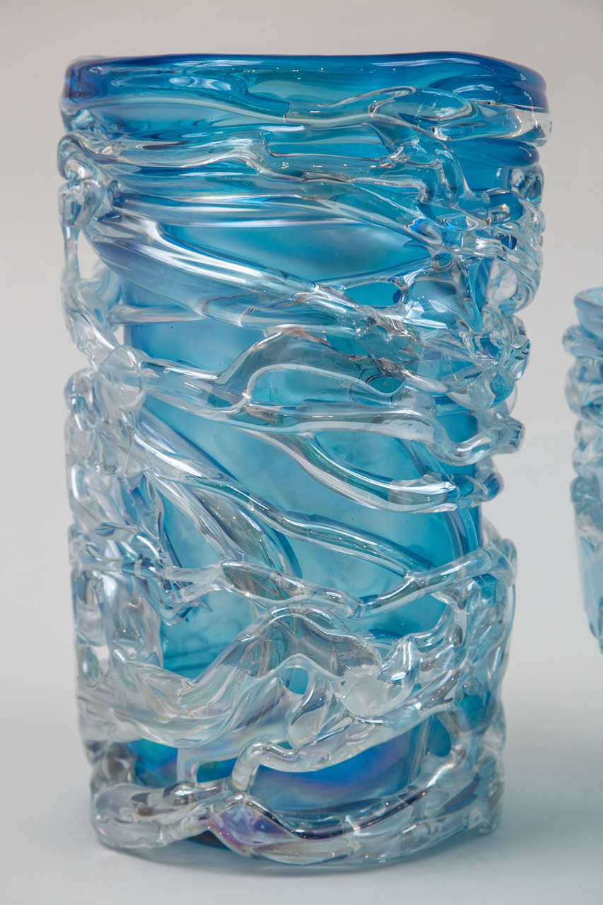 Exquisite translucent blue vase  thickly draped with iridescent frosted glass creating a dramatic three-dimensional quality, signed.
Largest cylindrical vase. .weighs 50 lbs 