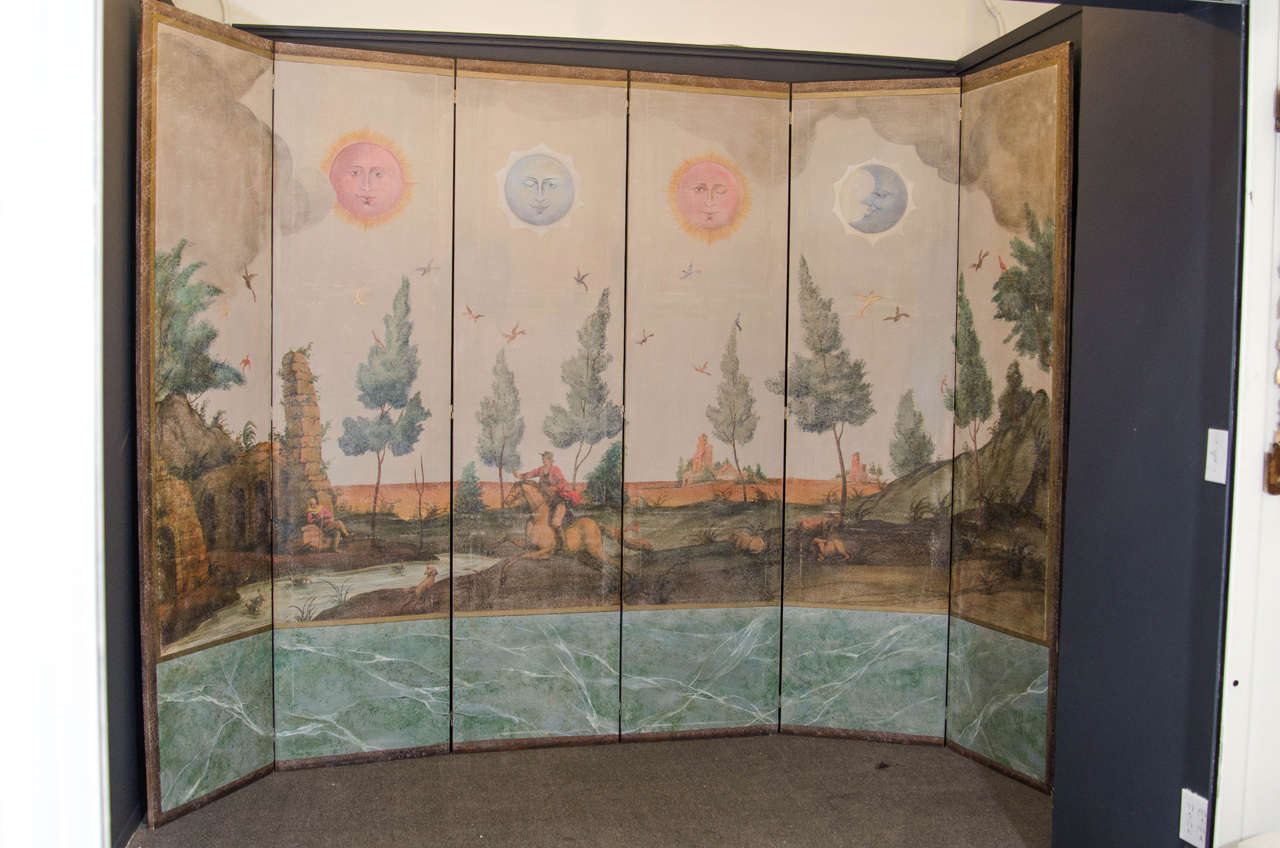 An early 20th century hand-painted decorative screen with colorful and vibrant landscape.  Scene of horse and rider, farm animals, and different phases of the sun and moon adorning the sky.

Good vintage condition with age appropriate