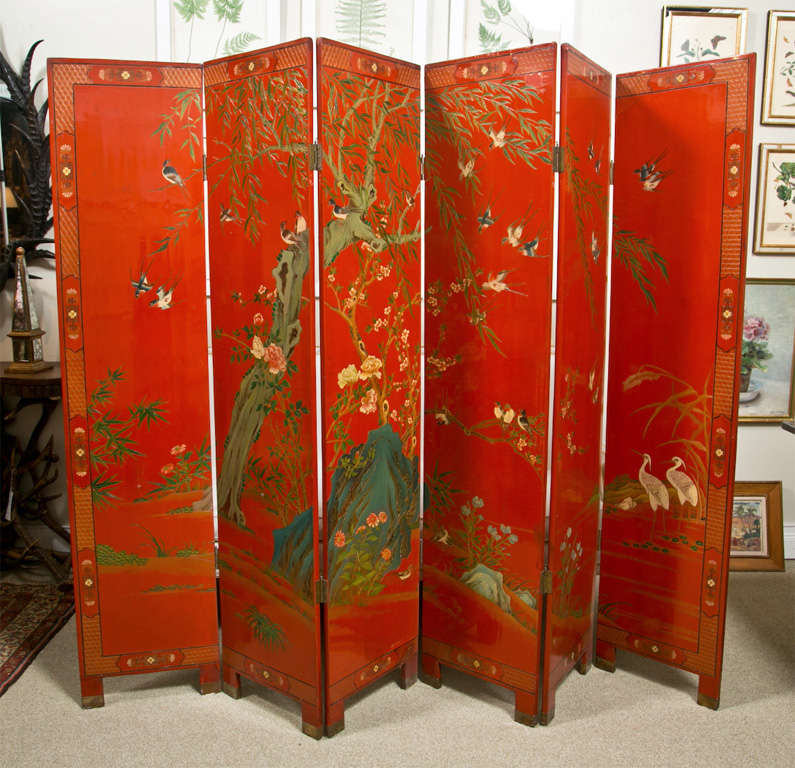 A red lacquered 6 panel screen painted on both sides with Asian landscape motif having different birds, flowers and trees.