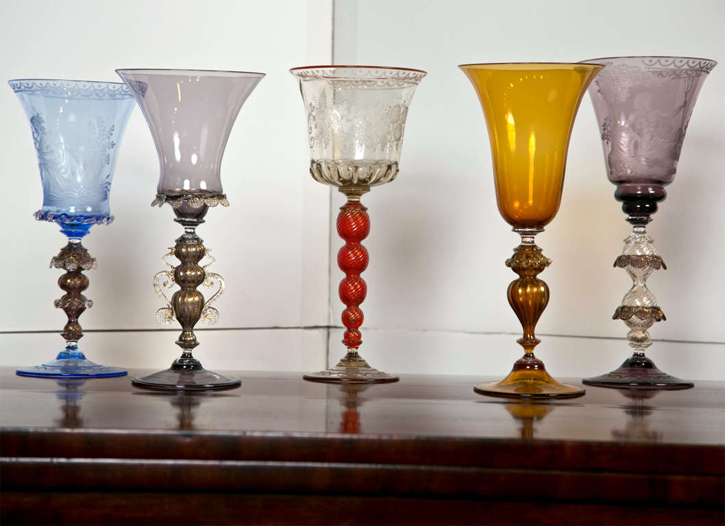Magnificent etched and blown Venetian glass goblets by Gianni Seguso, Vetro Artistco Murano. 

5 Available

1. Goblet with ruby stem, birds, and grape vine - $1,495.00
2. Amber goblet with gilt stem - $750.00
3. Goblet with blue cup, putti,