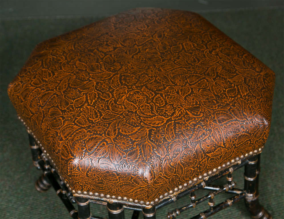 Very rare Hexagonal regency style faux bamboo stool in its original condition. Reupholstered in tooled leather.