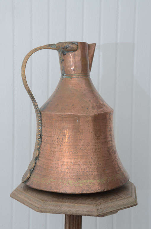 Old French Copper Pitcher once used in the kitchen. Made of copper it once allowed to heat the water in the fireplace. A beautiful sculptural object.