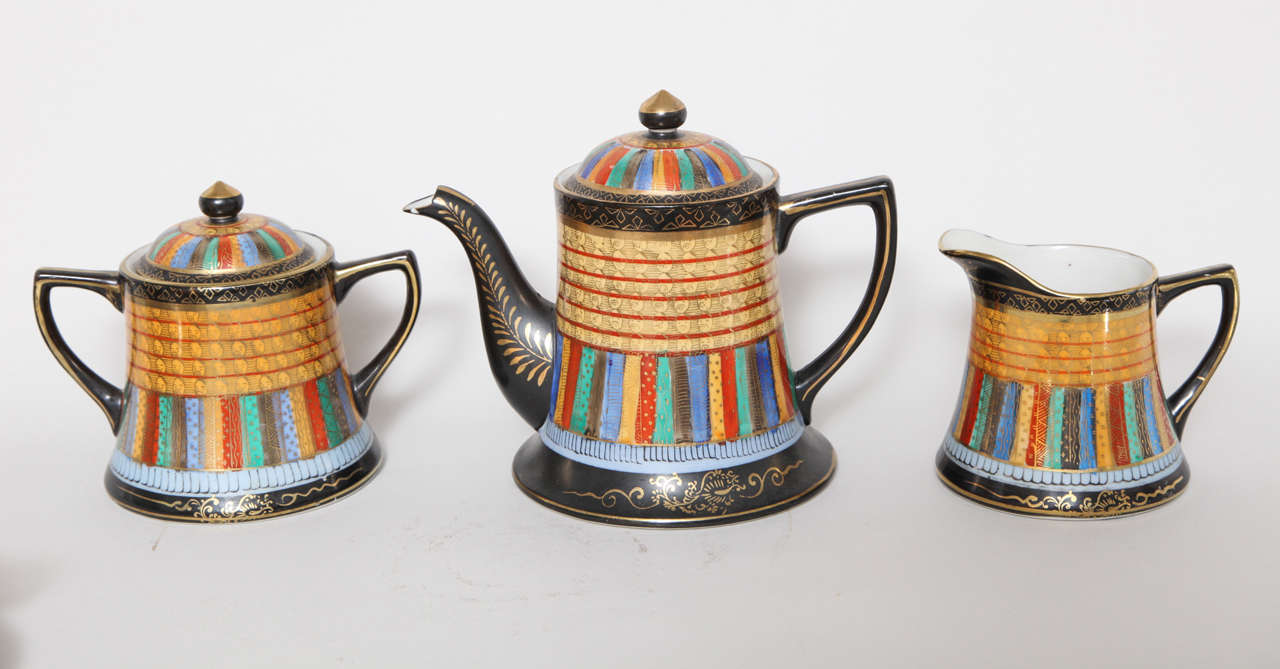 An elegant tea set with a Takito thousand face design by Nippon includes teapot creamer and lidded sugar.
