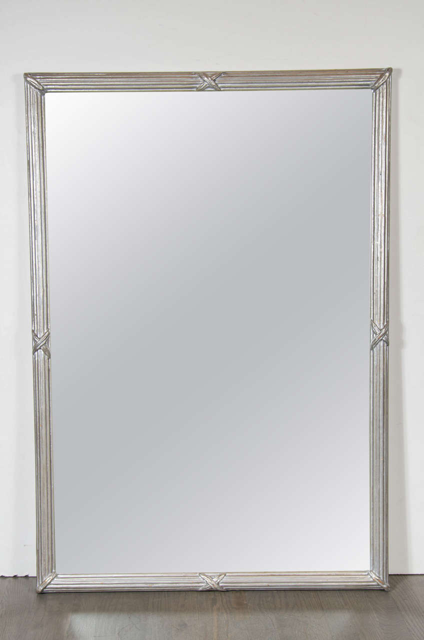 This great mirror features a stylized ribbed form detailing with X-form design all in hand rubbed silver-leaf. This mirror can be hung vertically or horizontally.