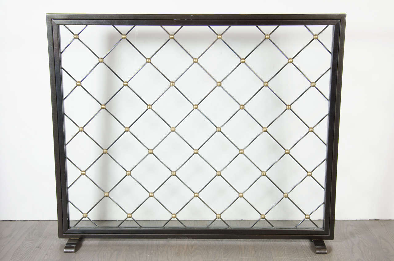 This fire screen features a cross hatch design in black enamel over the glass with gilt ball accents. This screen is in excellent condition .