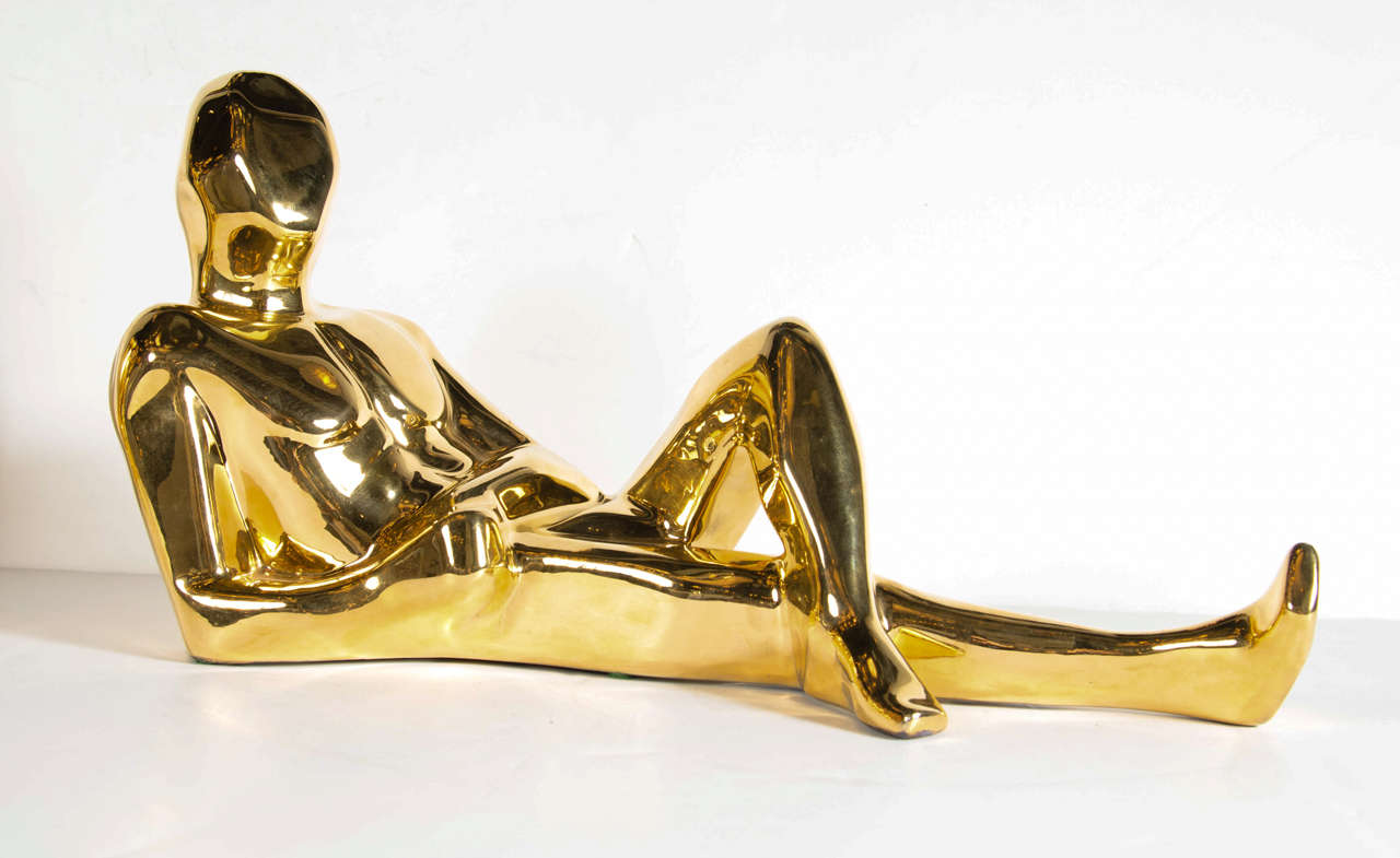 This gold-plated ceramic sculpture features a reclining figurative sculpture with stylized Cubist form. It bears the signature Jaru and is also dated 1977 as well.
