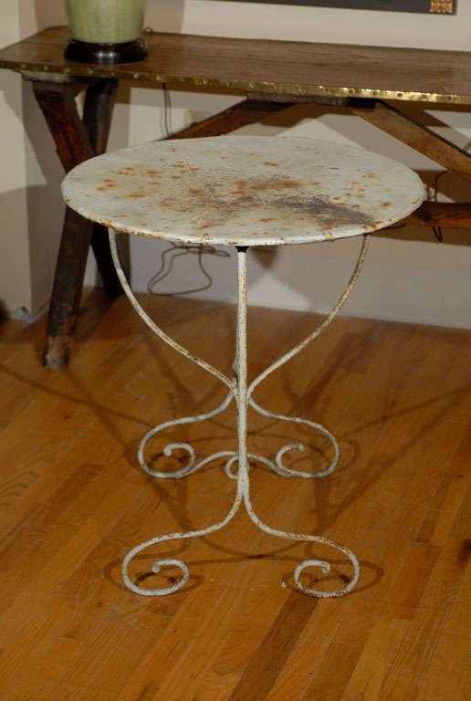 This is a wonderful table.  The details on the legs and stretcher are fabulous. The top can be folded down with a swing of the V shape underneath.  The V which looks like a wine glass is very typical of wine tasting tables.  
Please visit our
