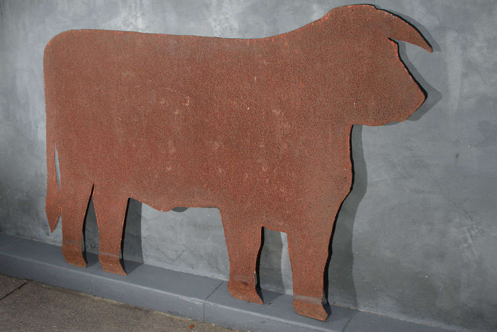 Large rusted steel silhouette of a cow. very simple and cool