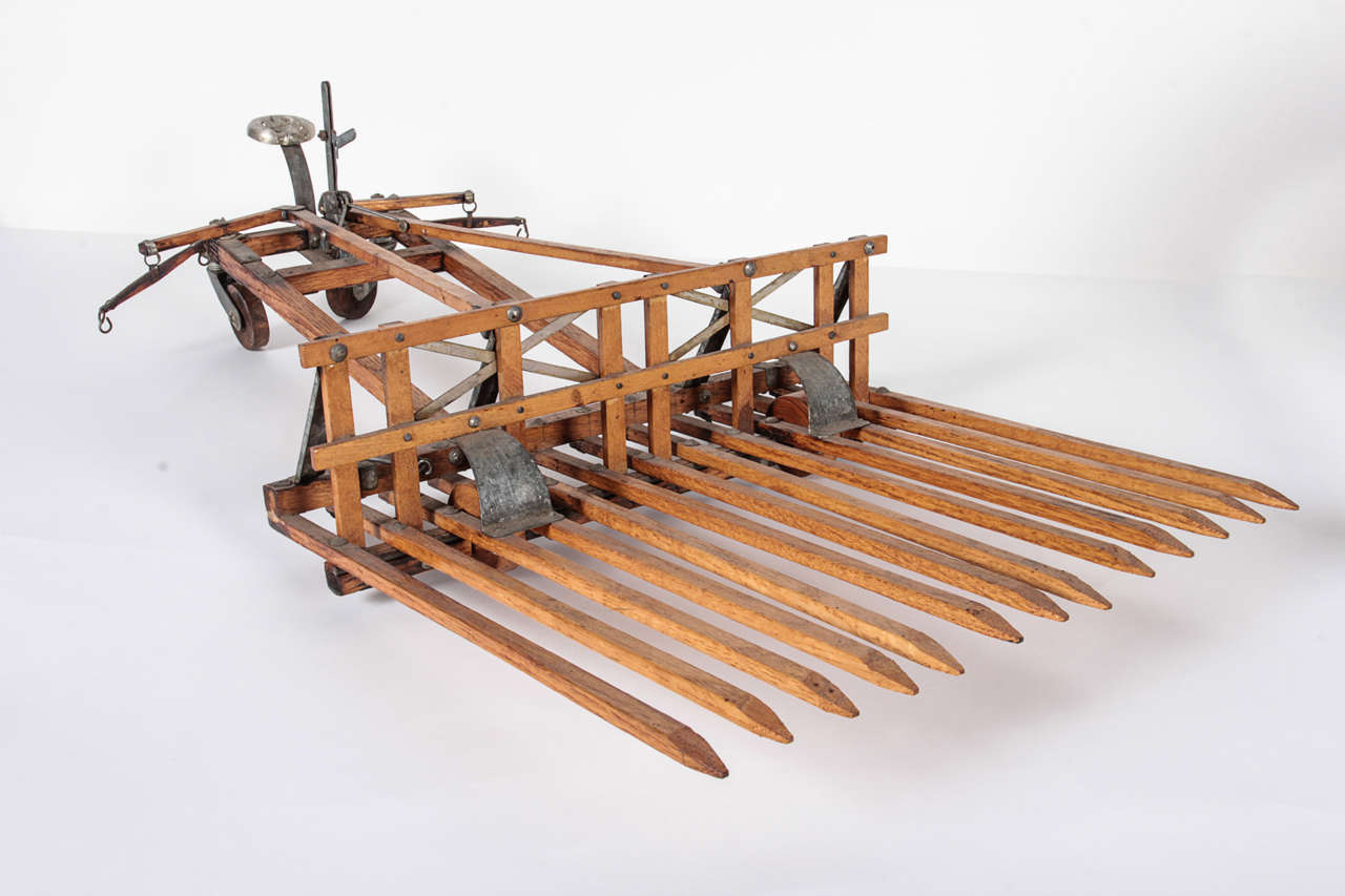 American, 19th c. patent model or salesman's sample of a horse drawn rake - a farm implement. Very rare, with moving mechanical parts. Exceptional in design and detail.